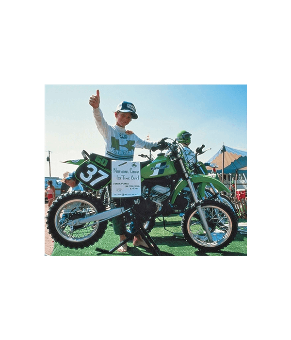 8-year-old “Hammerin” Hank Moree  poses next to the first-ever KX™60 (1983 pre-production) mini-bike.