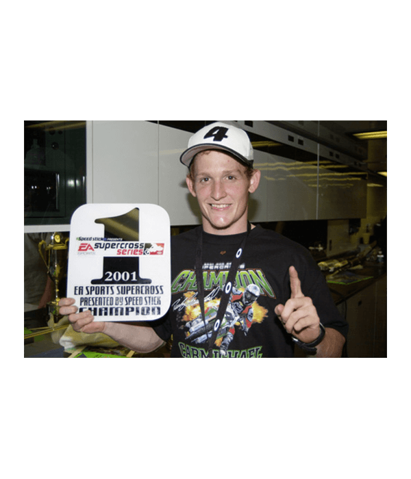 Ricky Carmichael holds the AMA Supercross and National Moto-Cross Championship sign
